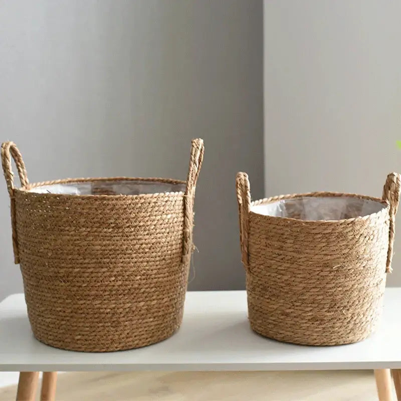 Two Nordic handmade straw woven flower pots on a table, perfect for creative and natural home decor or garden use.