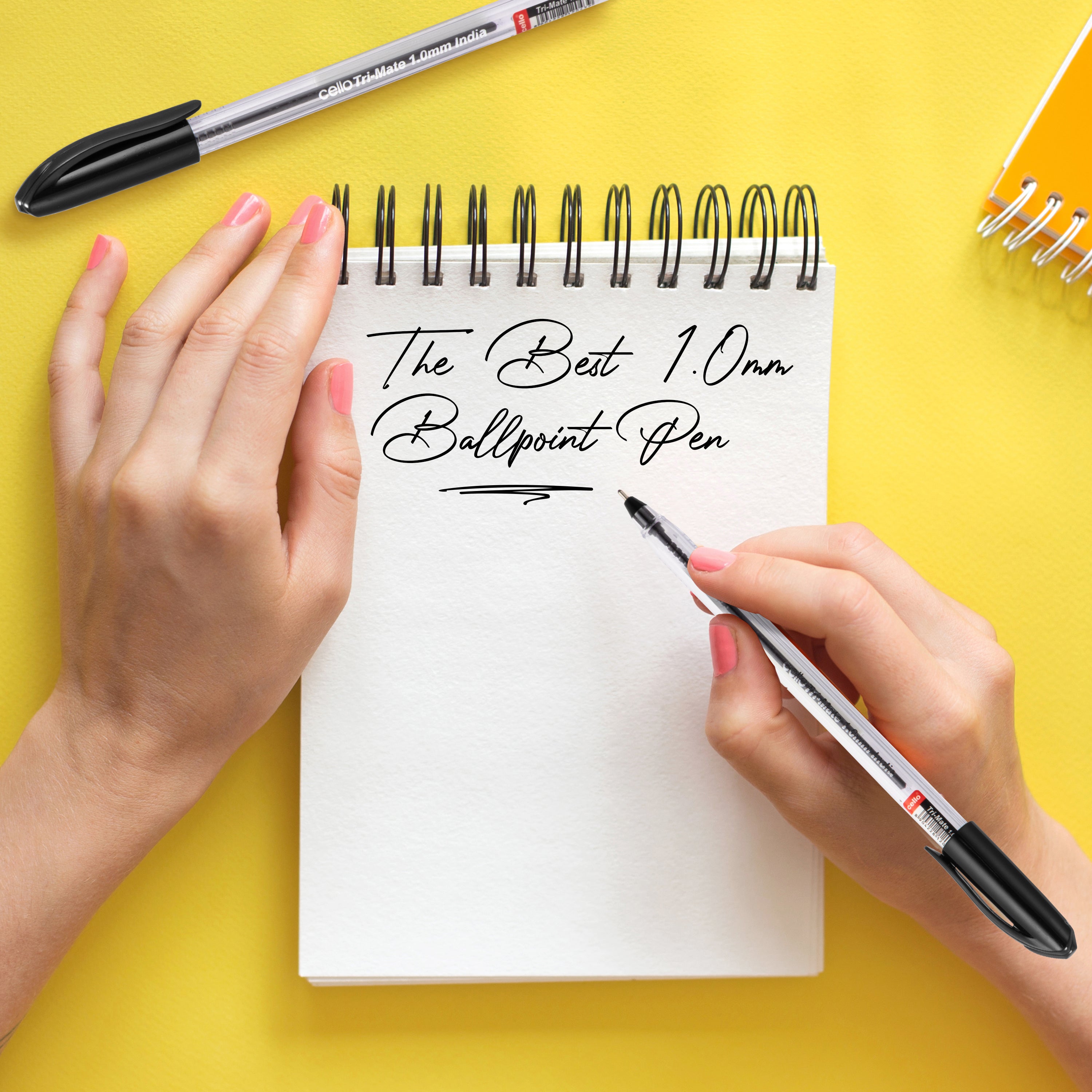 Handwriting with Cello Original Tri-Mate pen on notepad, showcasing smooth 1.0mm ballpoint writing on yellow background.