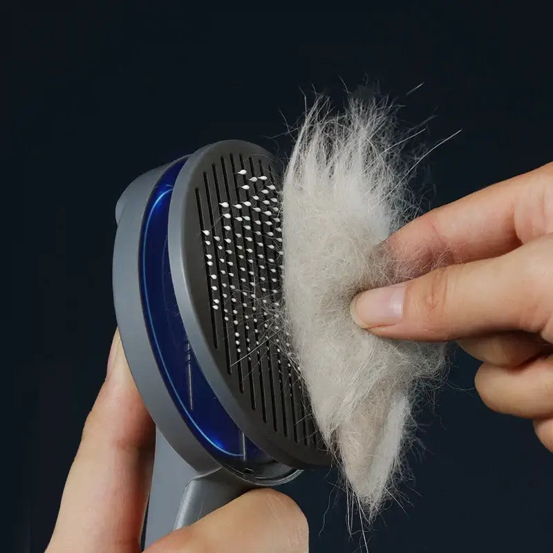 Person using self-cleaning pet grooming brush to remove fur from comb designed for cats, dogs, and rabbits.