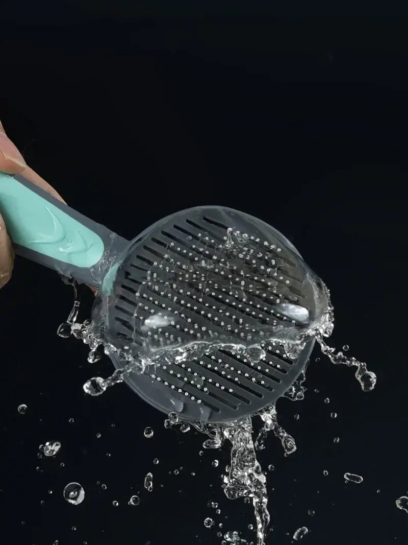 Pet grooming brush with self-cleaning feature under running water, perfect for combing dogs, cats, and rabbits.